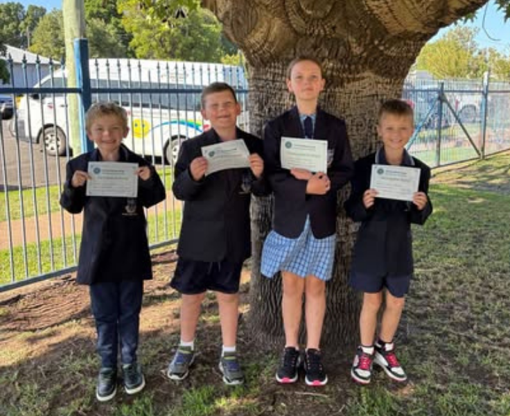 photo of 4 students with certificates from the CWA Public Speaking Competition